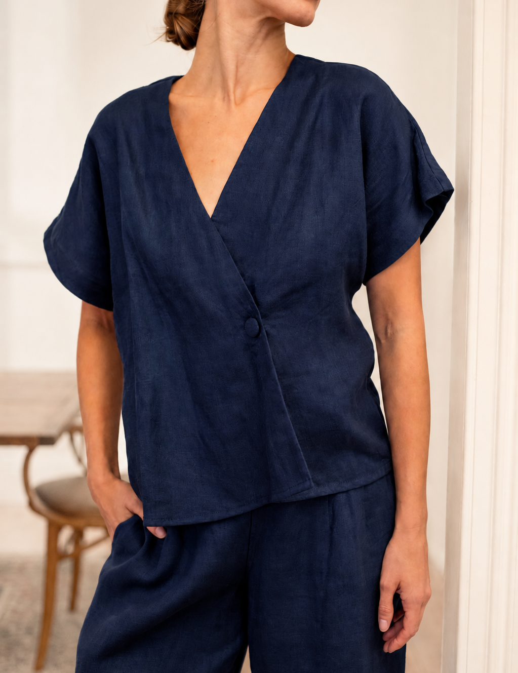 Model wearing a stylish outfit in an airy room featuring Newly Arrived Linen collection.