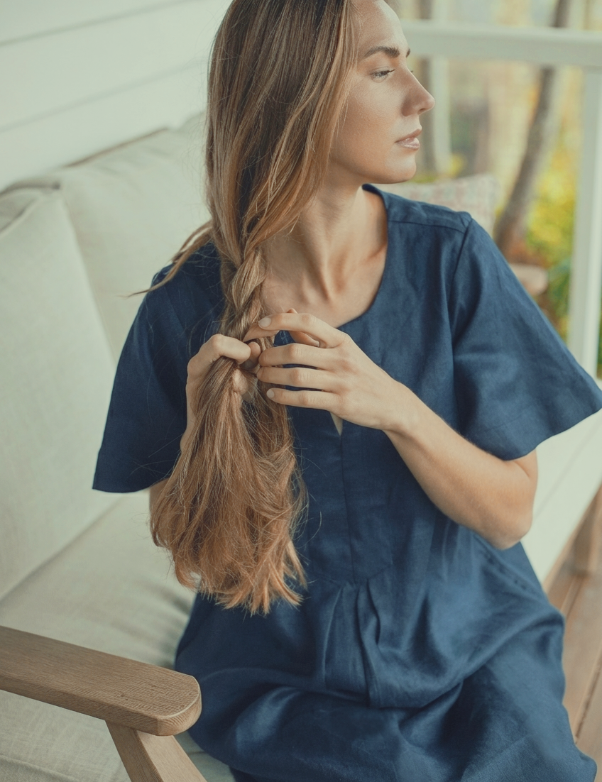 Model wearing the Charlotte Linen Dress Navy, showcasing elegant design and style.