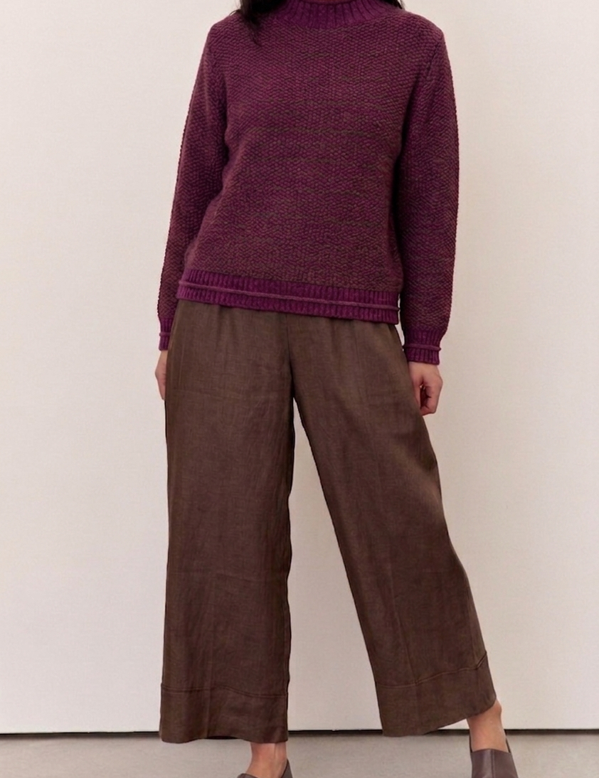 Model wearing a Willow Deep Plum Cotton Blend Jumper paired with brown wide-legged pants.
